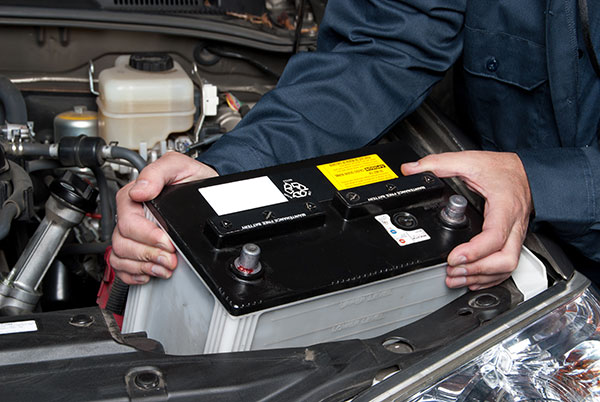 Mechanic installing car battery